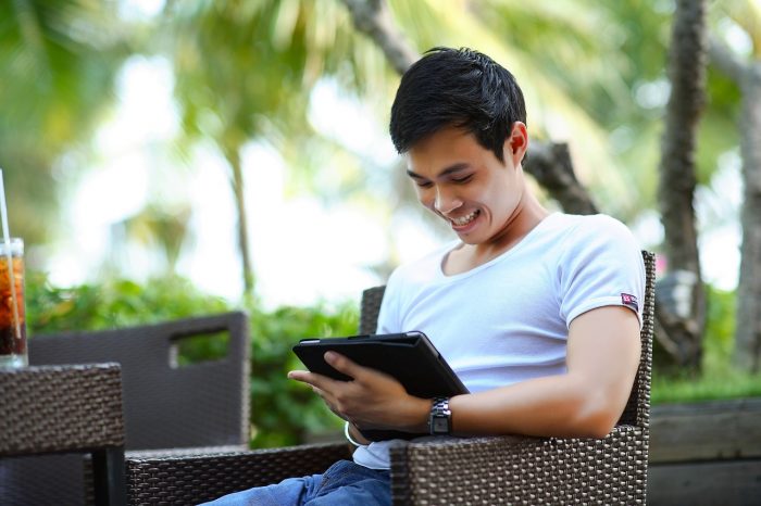 smiling-man-with-tablet-searches-for-chatbot-apps